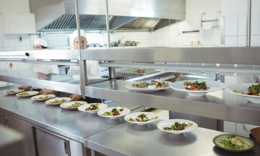 Chefs preparing food at order station