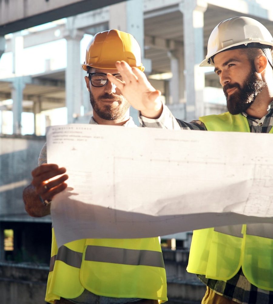 Portrait of construction engineers working on building site