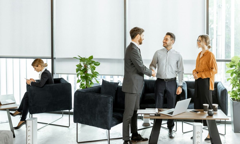 Young couple with financial advisor or agent at the office